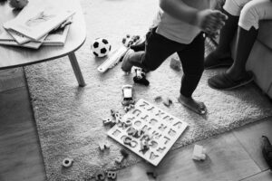 child running with toys on floor