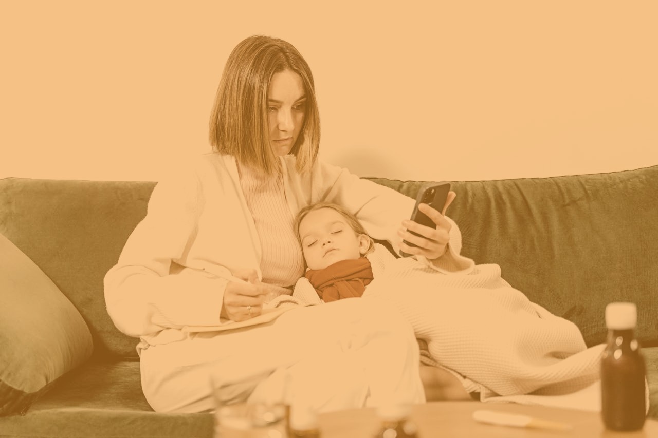 Mother cradles sick child